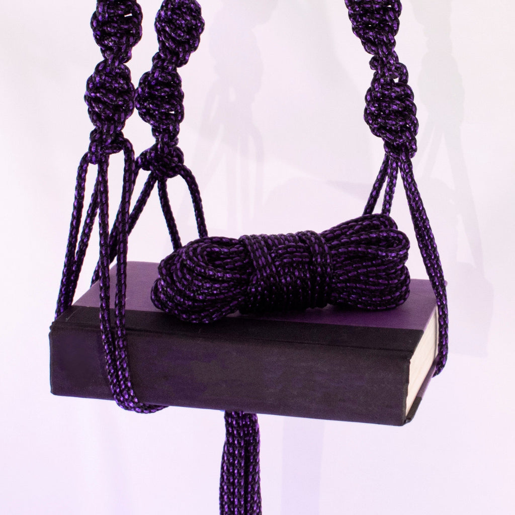 Purple and black 1/4 inch (6mm) solid braid MFP rope from Agreeable Agony bondage rope kit, shown in close-up detail.