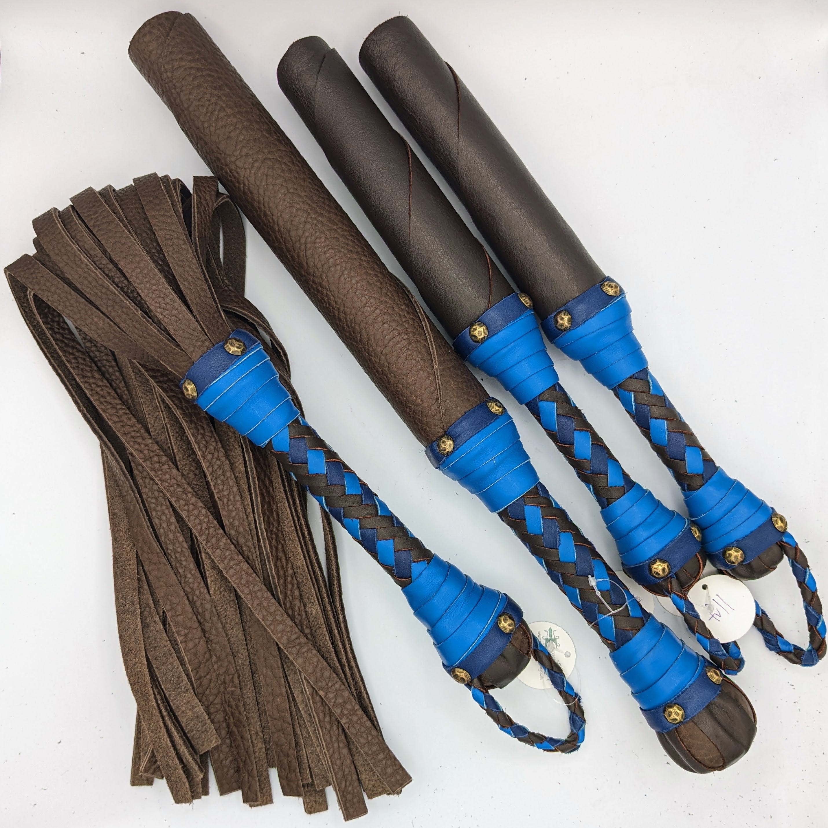 Custom leather impact toy kit from Agreeable Agony, featuring matching leather tools and accessories for impact play.