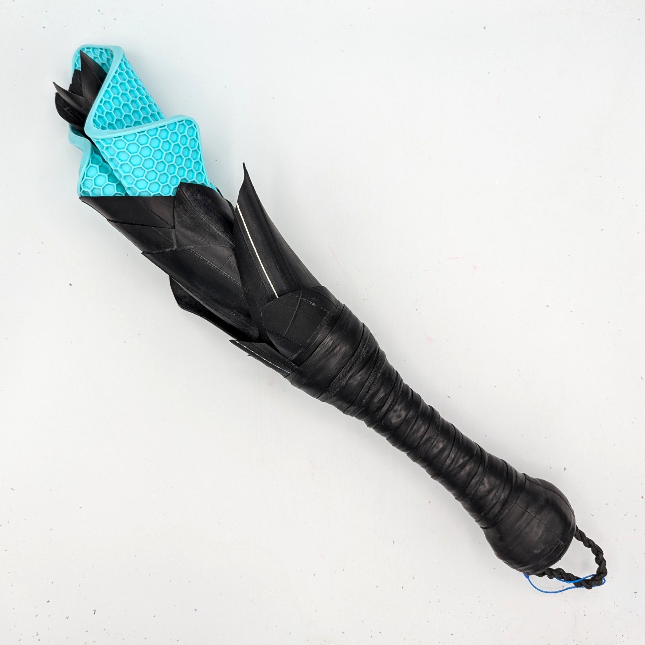 Rubber petal slapper paddle with floral design from Agreeable Agony, featuring a leather handle and colorful flower pattern.