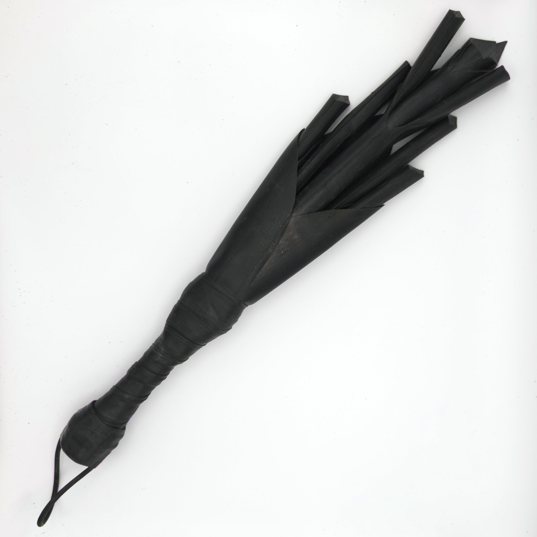 Agreeable Agony Petal Slapper rubber paddle with leather handle, flower design, used as a playful BDSM accessory.