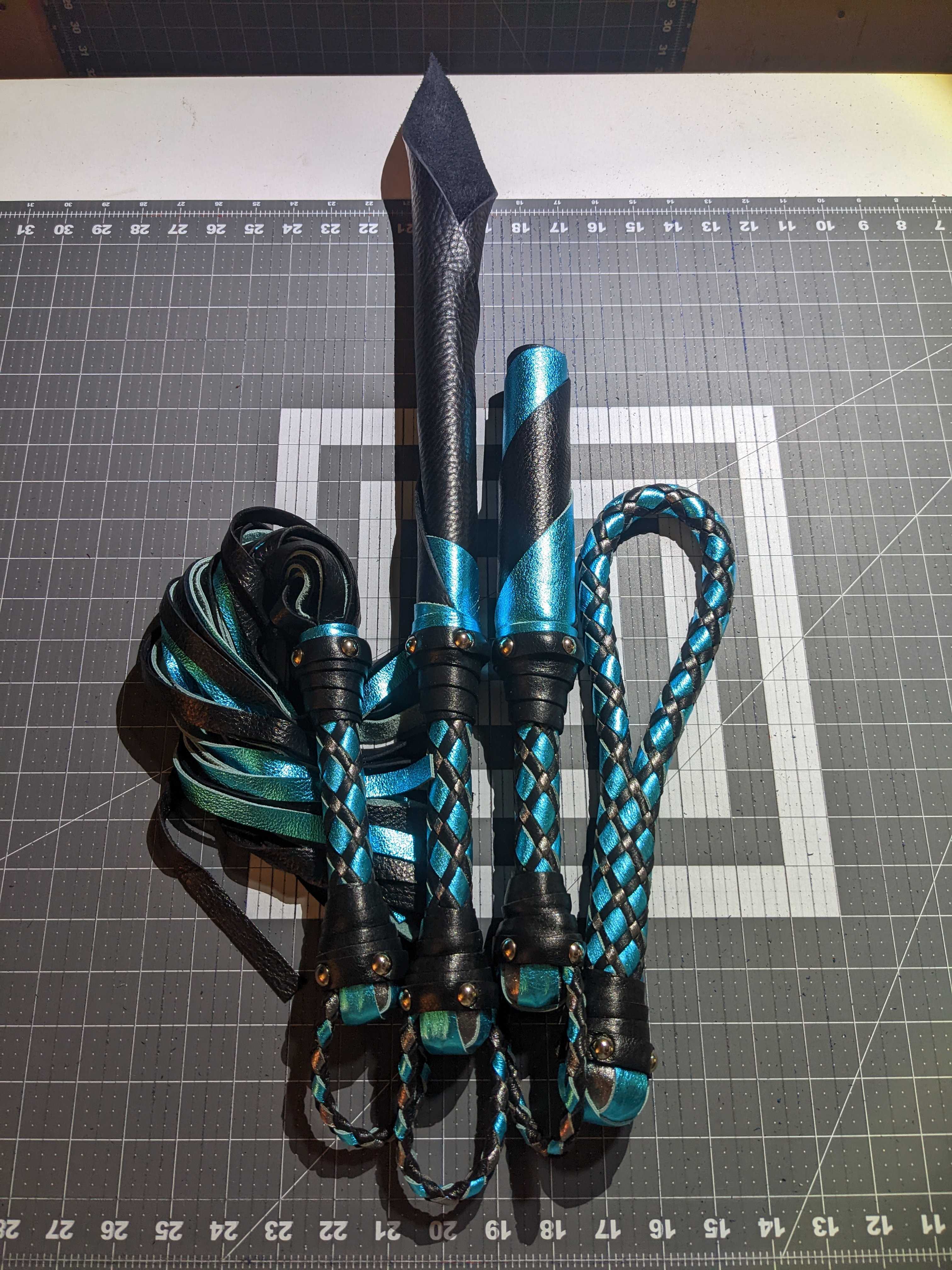 Leather impact toy kit by Agreeable Agony featuring matching custom leather accessories for impact play.
